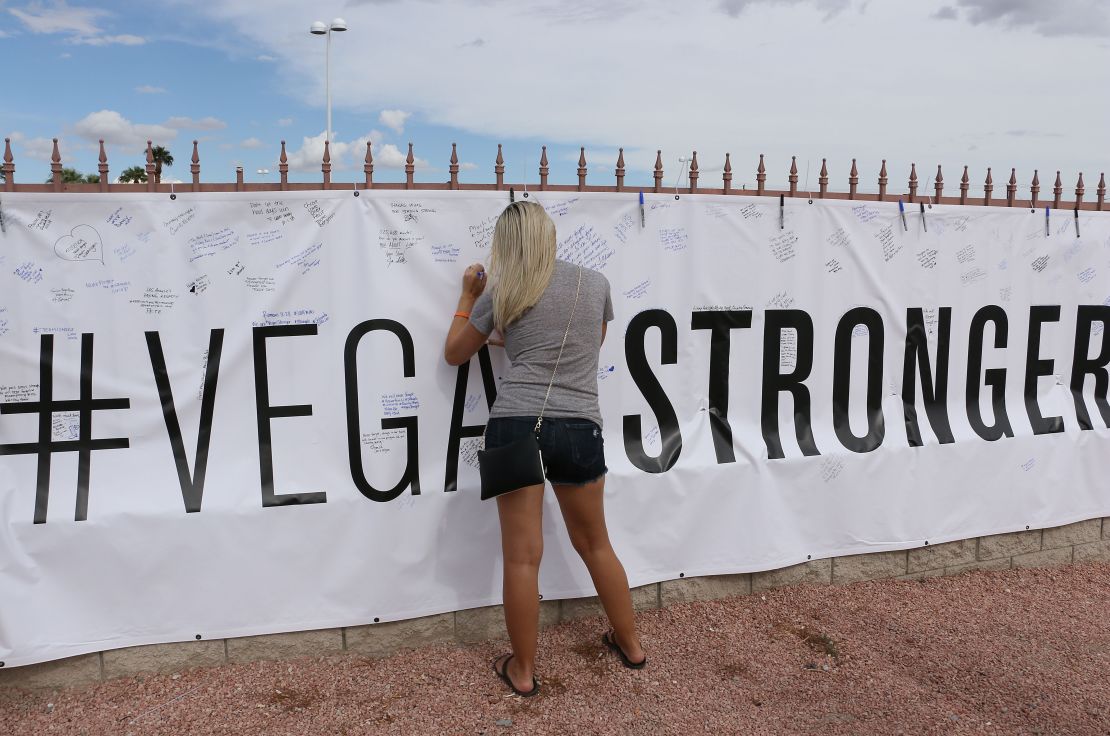 Shooting survivor Christina Bieker writes a message near the Route 91 Harvest Festival concert grounds. 