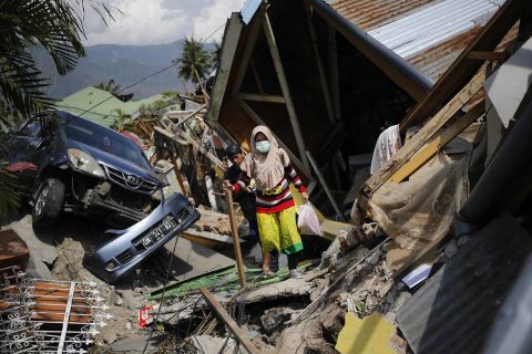 A woman makes her way through rubble in the Palu neighborhood of Balaroa on October 2.