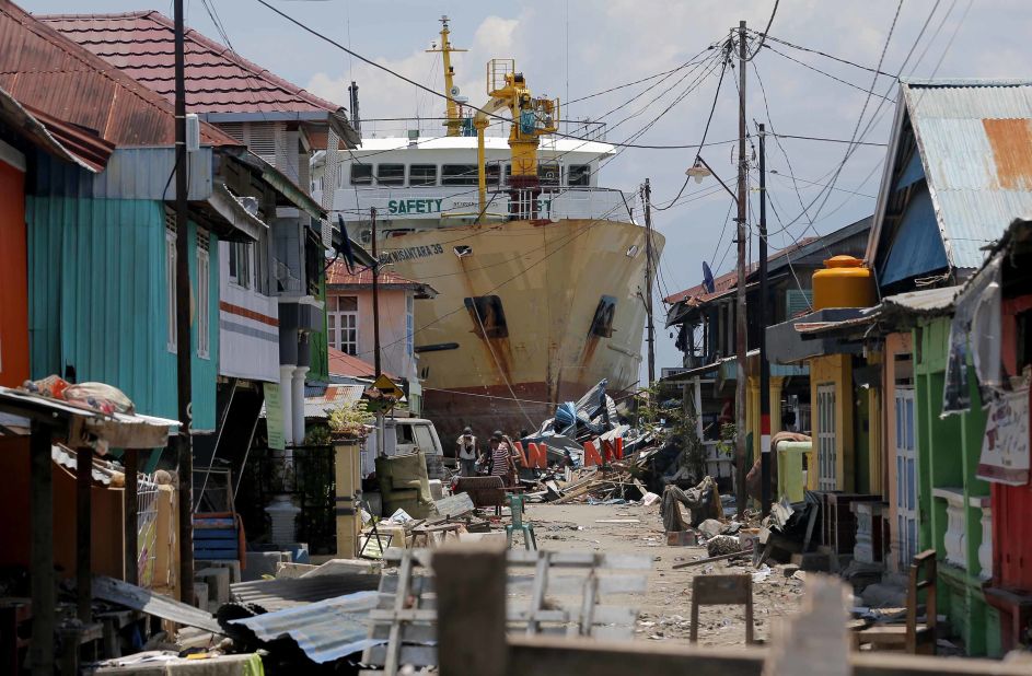A ship that was swept ashore during the tsunami rests near houses in Donggala on October 2.