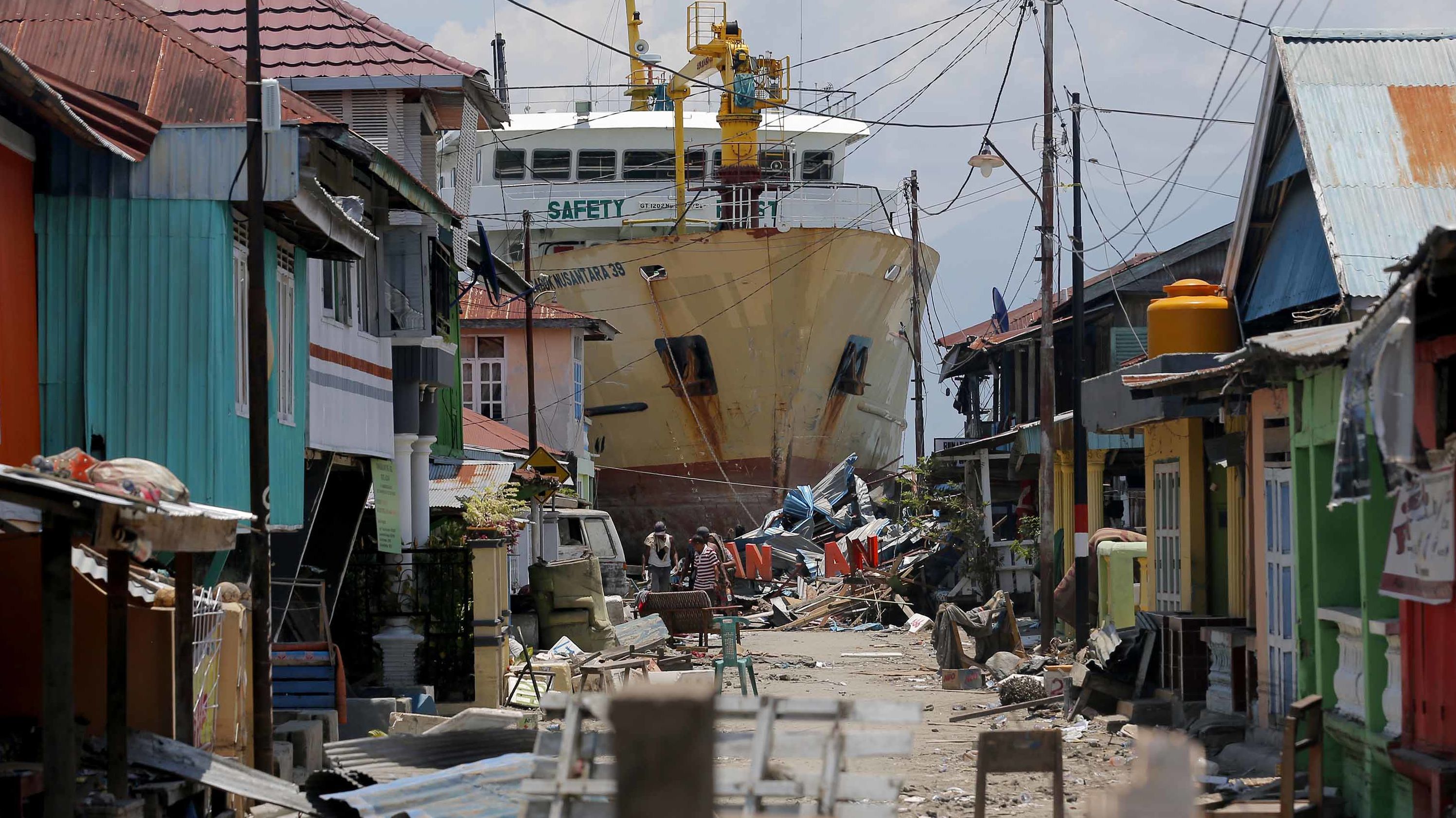 A ship that was swept ashore during the tsunami rests near houses in Donggala on October 2.