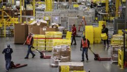 Employees pull pallet trucks at the Amazon.com Inc. fulfillment center in Robbinsville, New Jersey, U.S., on Monday, Nov. 27, 2017. The holiday shopping season is off to a strong start and retailers appear to be continuing the momentum today -- Cyber Monday -- the biggest online spending day of the year. Photographer: Victor J. Blue/Bloomberg via Getty Images