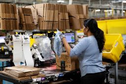 An employee packs a box at the Amazon fulfillment center in Robbinsville, New Jersey.