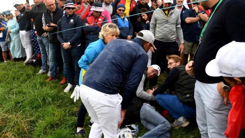 US golfer Brooks Koepka attends injured spectator Corine Remande at the Ryder Cup near Paris.