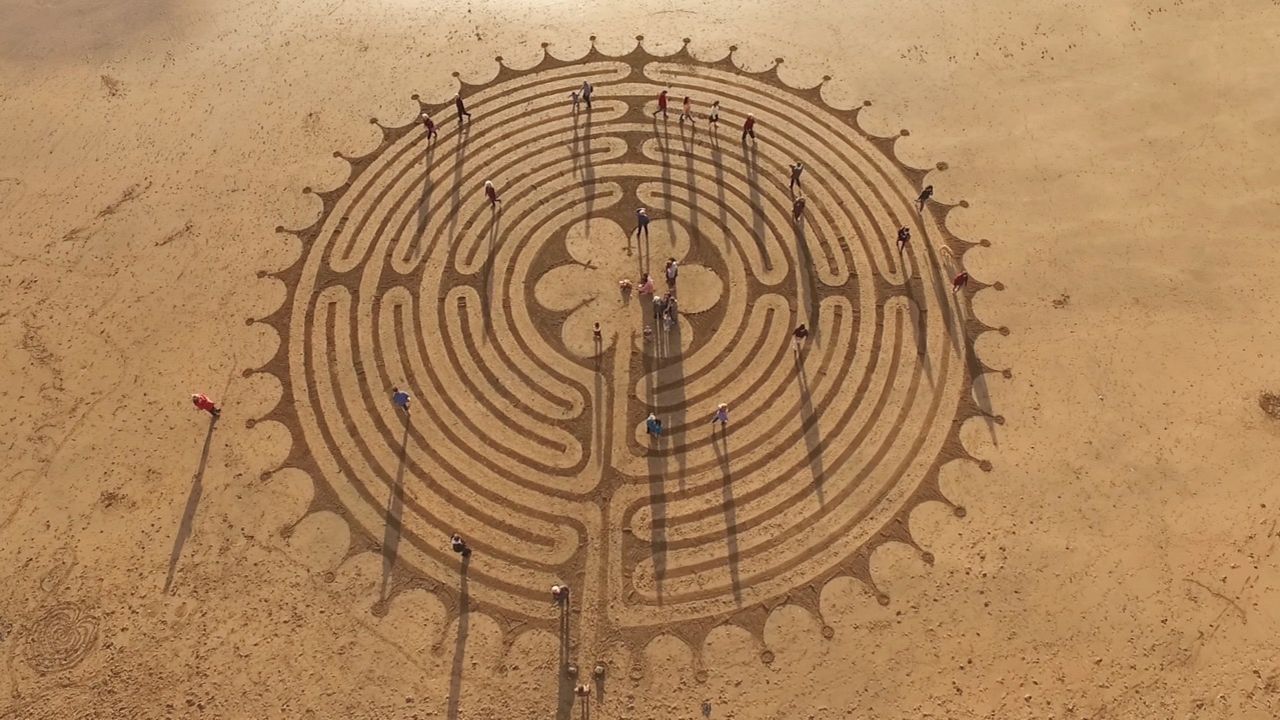 Creating the artwork with strangers is a bonding exercise. Pictured here: Chartres Labyrinth mural, Mwnt beach, Ceredigion, Wales