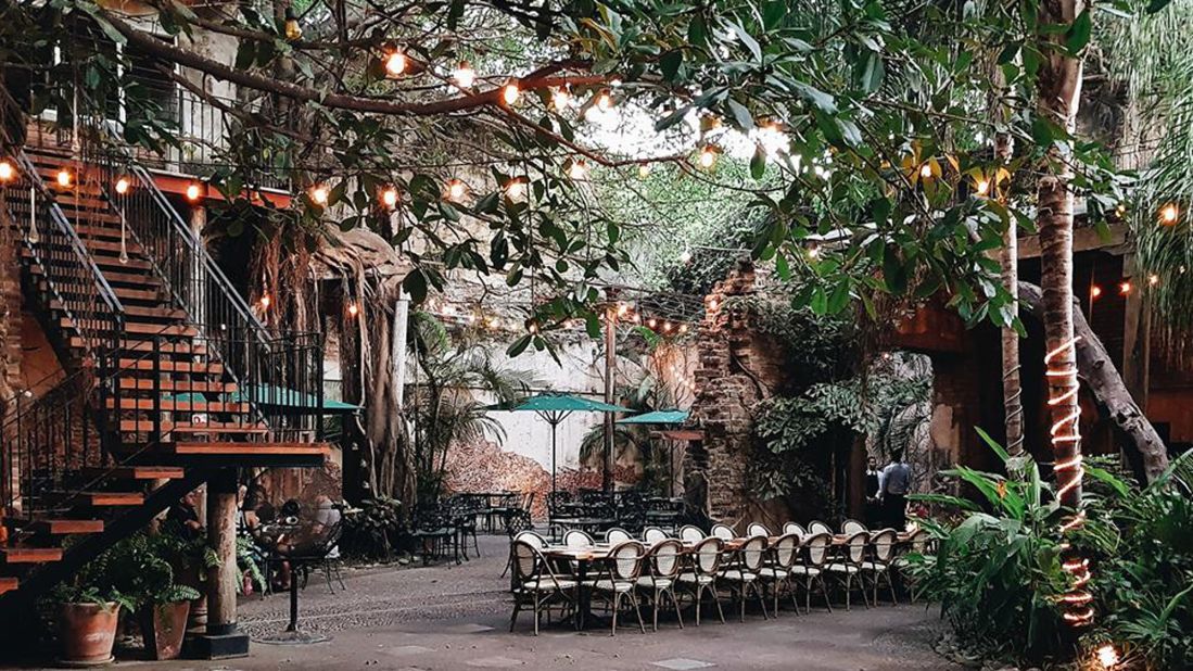 <strong>El Presidio:</strong> This is probably the most stunning setting for dinner that you can find. The open-air central courtyard is full of old trees with roots climbing down the walls. 