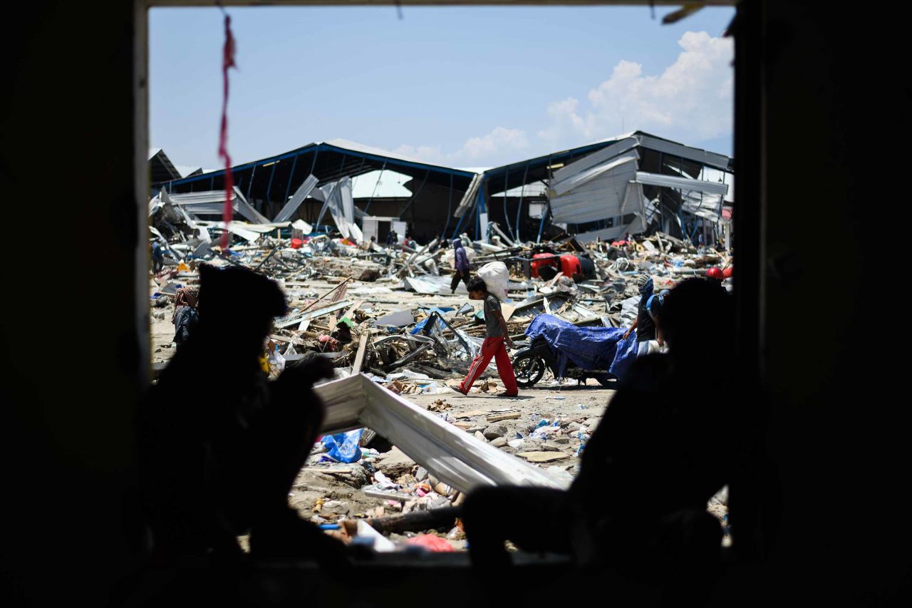 Quake survivors salvage items from the debris of a factory complex in Palu.