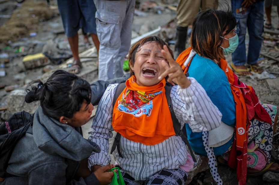 A woman mourns in Palu on Tuesday, October 2, after her relatives were found to have died in the earthquake.