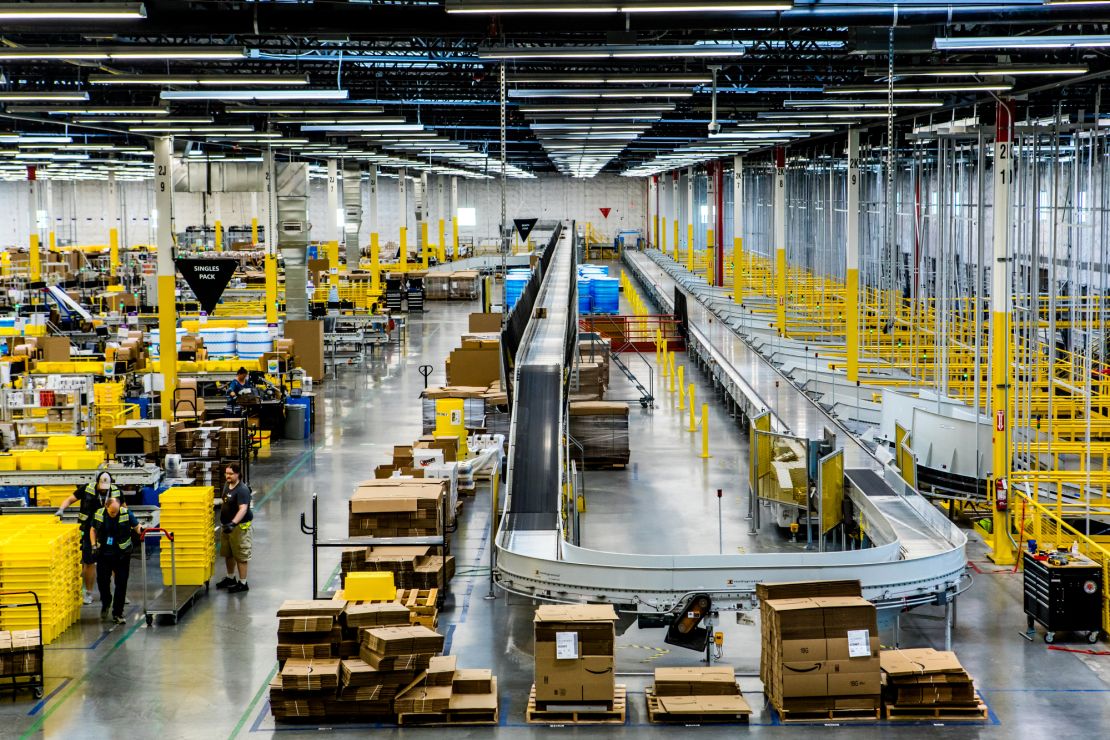 Inside an Amazon fulfillment center, a conveyer belt is used to organize packages.