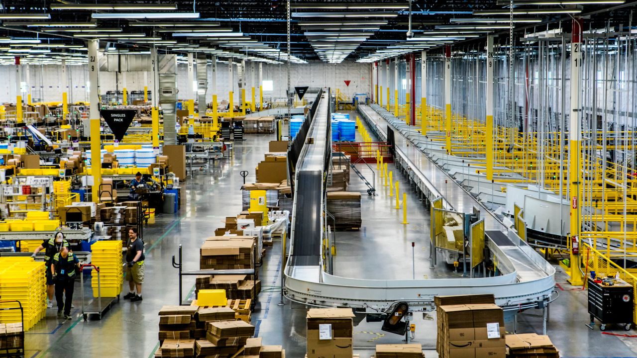Inside an Amazon fulfillment center, a conveyer belt is used to organize packages.