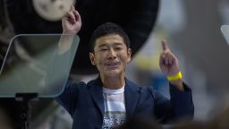 Japanese billionaire Yusaku Maezawa reacts during the announcement by Elon Musk to be the first private passenger who will fly around the Moon aboard the SpaceX BFR launch vehicle, at the SpaceX headquarters and rocket factory on September 17, 2018 in Hawthorne, California. - Japanese billionaire businessman, online fashion tycoon and art collector Yusaku Maezawa was revealed as the first tourist who will fly on a SpaceX rocket around the Moon. (Photo by DAVID MCNEW / AFP)        (Photo credit should read DAVID MCNEW/AFP/Getty Images)