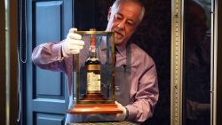 A Bonhams porter shows the bottle of Macallan Valerio Adamai 1926 whisky which sold for a world record sale price of £700,000 at auction in Edinburgh on October 3, 2018. - The whisky, which was in a vat for 60 years from 1926 then bottled, fetched £700,000 plus a £148,000 sales premium to make it the most expensive whisky for £848,000. (Photo by Andy Buchanan / AFP)        (Photo credit should read ANDY BUCHANAN/AFP/Getty Images)