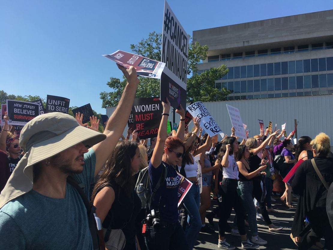 Protesters opposed to Brett Kavanaugh's nomination to the Supreme Court march through the streets of Washington on October 4, 2018. 