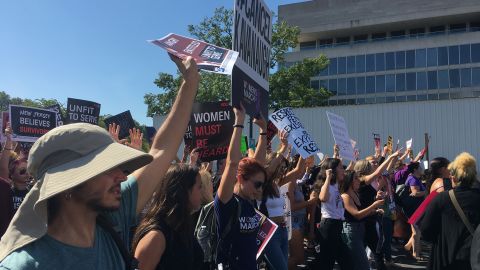 Protesters opposed to Brett Kavanaugh's nomination to the Supreme Court march through the streets of Washington on October 4, 2018.