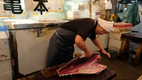 This picture taken on September 27, 2018 shows a man working at a wholesale store at the Tsukiji fish market in Tokyo. - For decades, Tokyo's Tsukiji market has been the beating heart of a world-class culinary capital, supplying Michelin-starred chefs and drawing tourists who queue for hours to glimpse pre-dawn tuna auctions. But this week it will finally shut its doors and relocate from its dilapidated but central location to a new site in eastern Tokyo, after a lengthy and controversial process, hindered by pollution rows and construction delays. (Photo by Kazuhiro NOGI / AFP) / TO GO WITH AFP STORY JAPAN-FISHING-FOOD-TSUKIJI-TOYOSU,ADVANCER BY SARA HUSSEIN        (Photo credit should read KAZUHIRO NOGI/AFP/Getty Images)