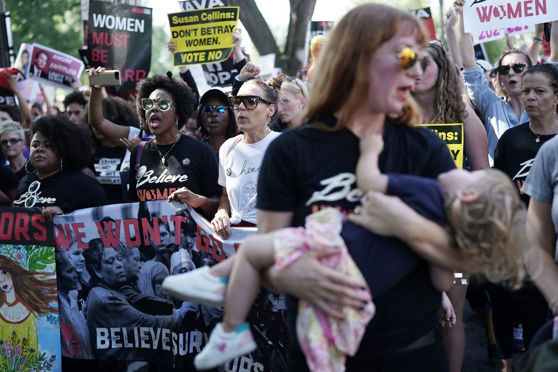 Demonstrators shout slogans as they march toward the US Supreme Court for a rally on October 4, 2018 in Washington, DC. 