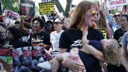 WASHINGTON, DC - OCTOBER 04:  Demonstrators shout slogans as they march towards U.S. Supreme Court for a rally October 4, 2018 in Washington, DC. Activists are holding a rally to protest against Supreme Court associate justice nominee Brett Kavanaugh.  (Photo by Alex Wong/Getty Images)