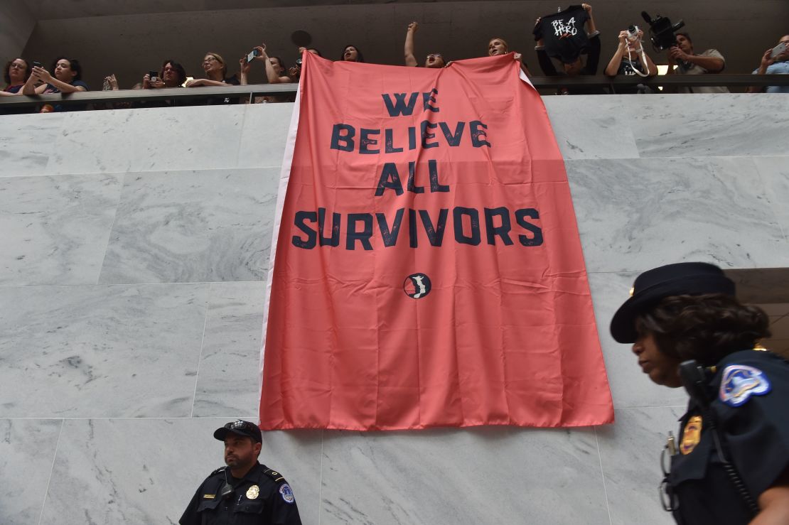 Demonstrators protest US Supreme Court nominee Brett Kavanaugh and hang a banner proclaiming, "We believe survivors" on Capitol Hill on October 4.