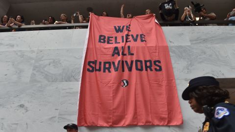 Demonstrators protest US Supreme Court nominee Brett Kavanaugh and hang a banner proclaiming, "We believe survivors" on Capitol Hill on October 4.