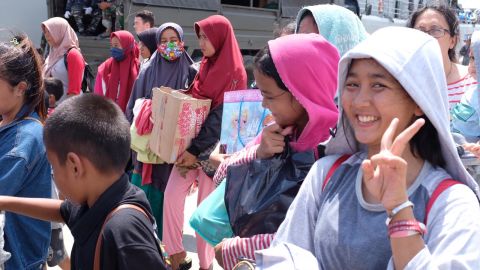 Hopeful passengers wait on the dock at Palu on Thursday, enthusiastic to board an Indonesian naval vessel which will take them away.