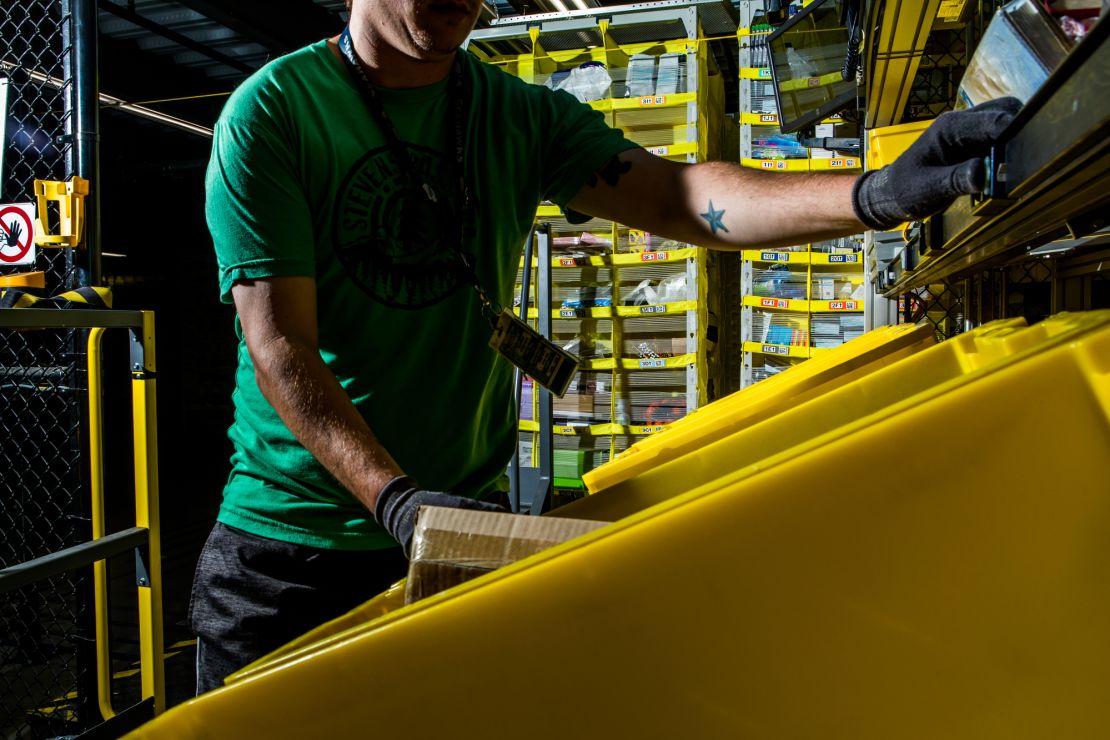 An employee goes through a bin at the fulfillment center.