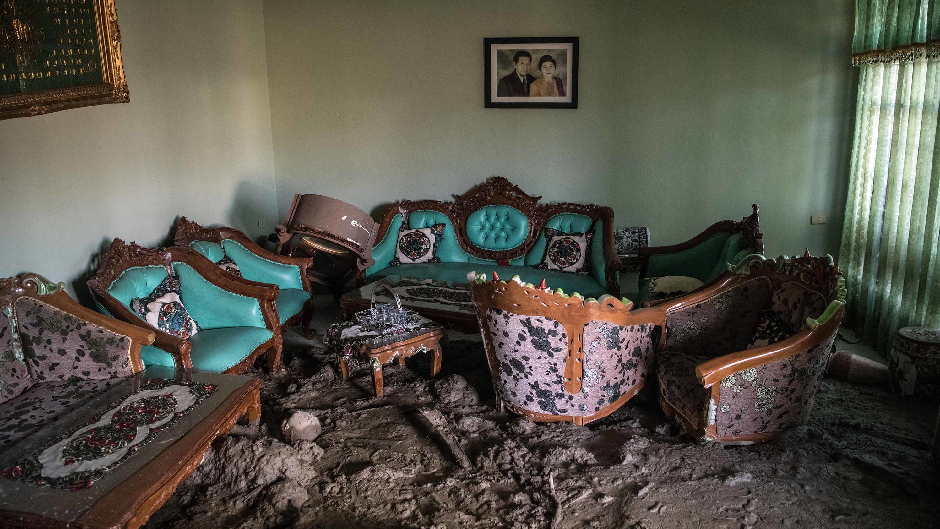 Furniture sits partially submerged in mud in a Palu house on October 4.
