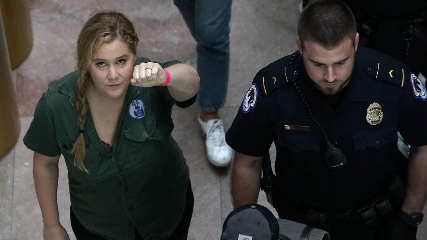 WASHINGTON, DC - OCTOBER 04:  Comedian Amy Schumer (L) is led away after she was arrested during a protest against the confirmation of Supreme Court nominee Judge Brett Kavanaugh October 4, 2018 at the Hart Senate Office Building on Capitol Hill in Washington, DC. Senators had an opportunity to review a new FBI background investigation into accusations of sexual assault against Kavanaugh and Republican leaders are moving to have a vote on his confirmation this weekend. (Photo by Alex Wong/Getty Images)