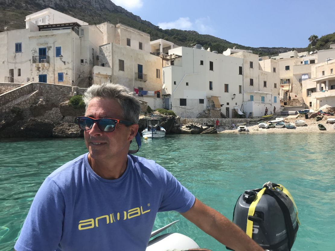 Jonathan steers the dinghy back to the boat after a shopping trip to Levanzo in Sicily's Egadi Islands. There was just one small grocery store on this island and it had sold out of fresh milk and bread.