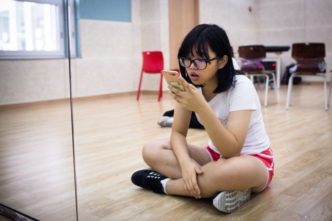 Yang Fang Chi, 17 years old, practices her singing before class at Global K.  