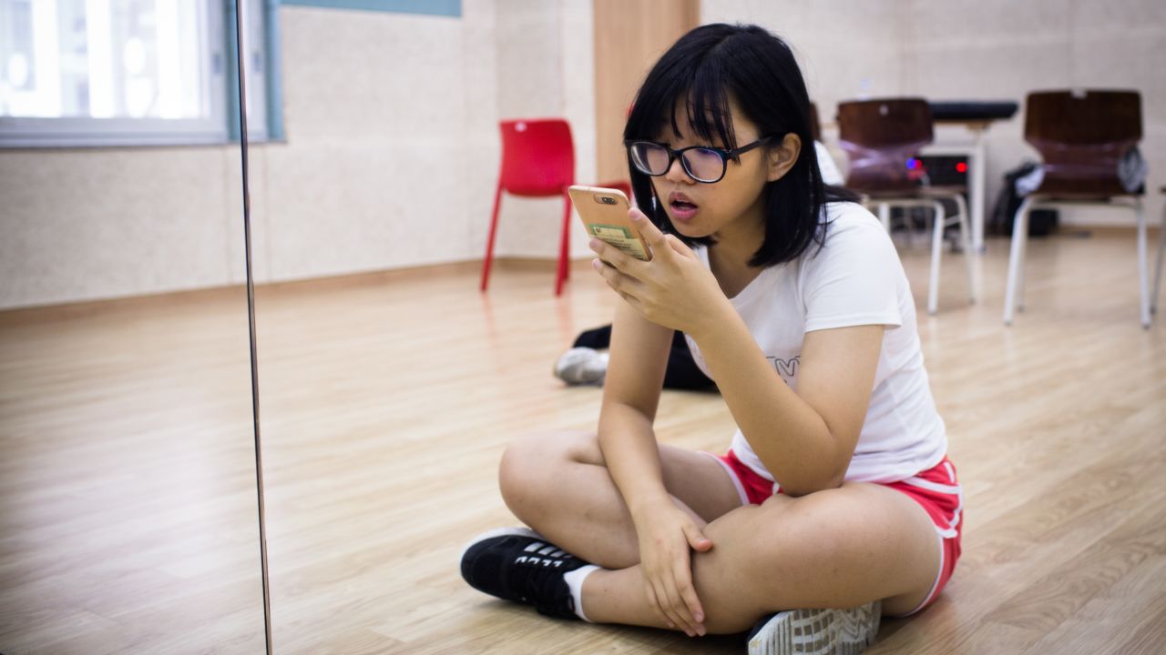 Yang Fang Chi, 17 years old, practices her singing before class at Global K.