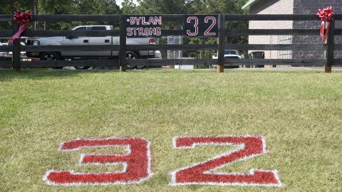 Red ribbons, the number 32 and "#DylanStrong" are seen in front of a small business Friday in Zebulon, Georgia, the home of Pike County High School.