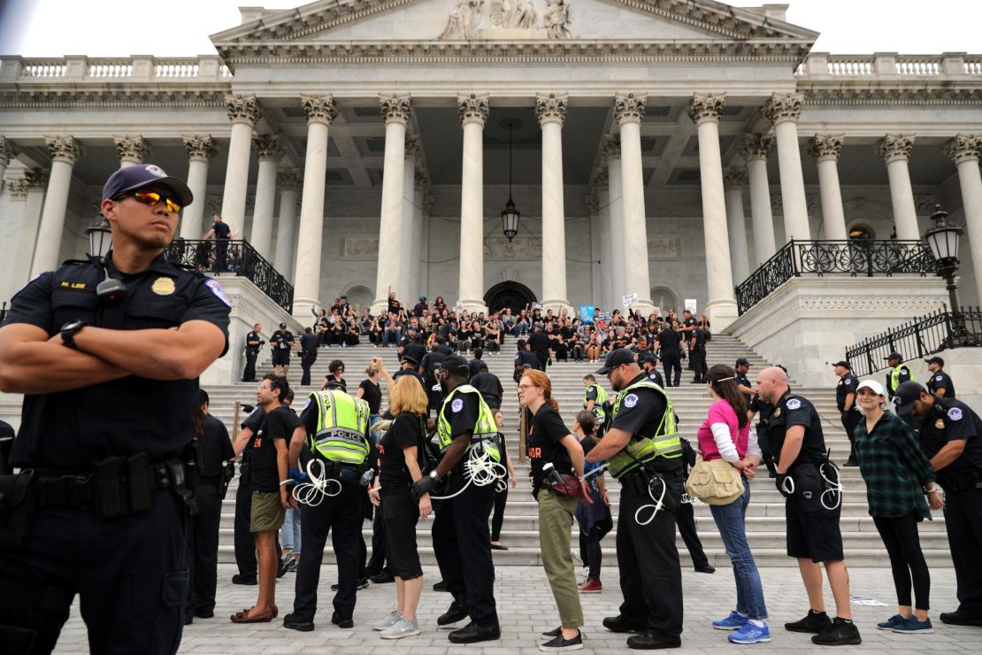 Capitol Police arrest protesters Saturday after they occupied the center steps of the east front of the US Capitol.