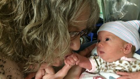 Jamie McNeil holds her granddaughter, Delly Adams.