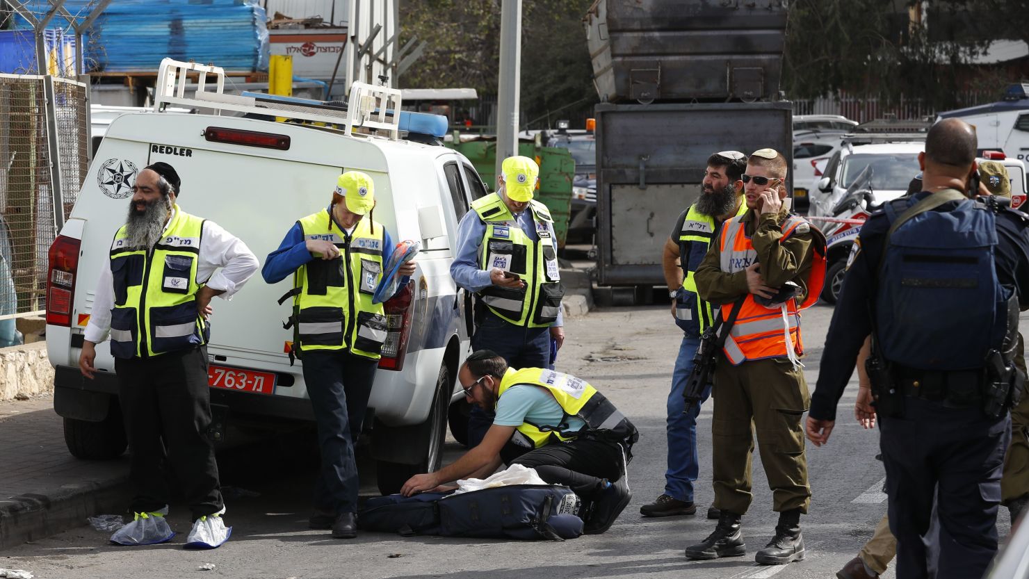 Israeli Zaka volunteers gather at the site of the attack at the Barkan Industrial Park on Sunday.