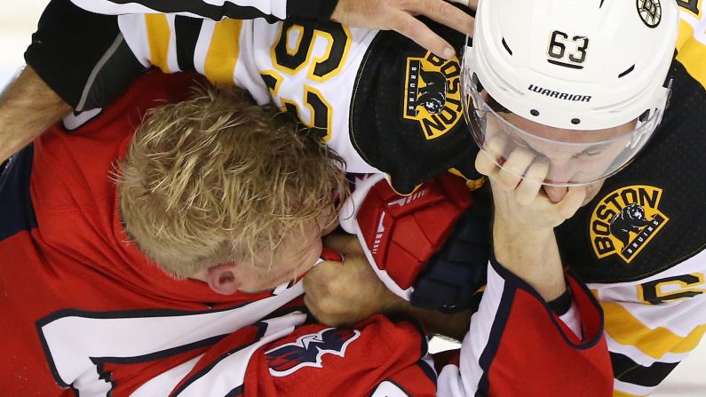 Washington Capitals center Lars Eller grasps at the face of Boston Bruins left wing Brad Marchand in the third period on October 3, 2018 at Capital One Arena.