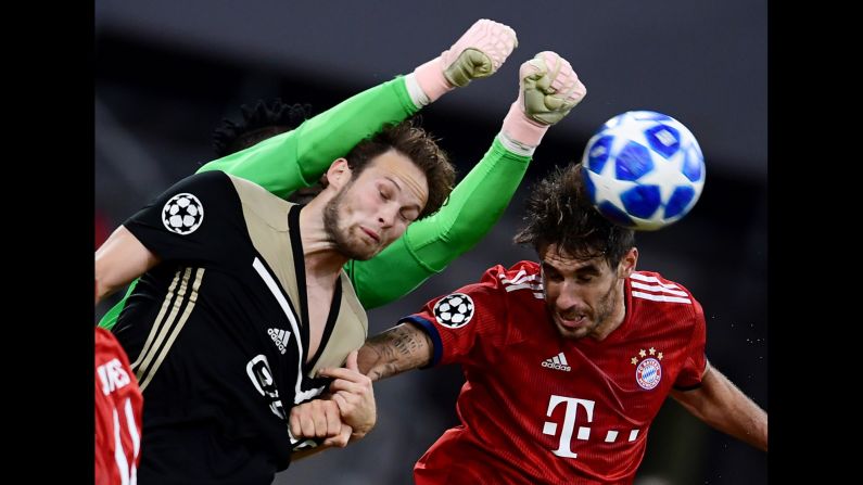 Javi Martinez of Bayern Munich, and Daley Blind and goalkeeper Andre Onana of Ajax Amsterdam fight for the ball in the air during a Champions League match on October 2, 2018.