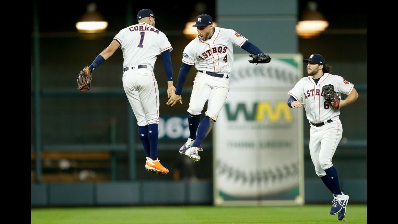 Carlos Correa, George Springer and Jake Marisnick of the Houston Astros celebrate after defeating the Cleveland Indians 3-1 in Game Two of the American League Division Series at Minute Maid Park in Houston, Texas.