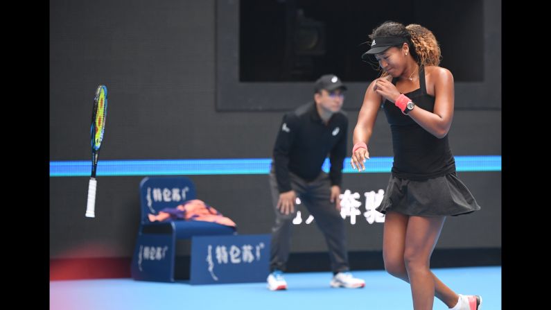 Naomi Osaka of Japan throws her racquet during her women's quarter-final match against Zhang Shuai of China at the China Open tennis tournament in Beijing on October 5, 2018. Osaka advanced to the semi-finals where she was defeated in two sets by Anastasija Sevastova.