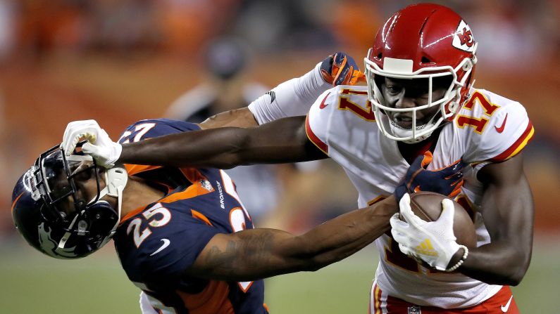 Kansas City Chiefs wide receiver Chris Conley stiff arms Denver Broncos defensive back Chris Harris during the second half of their game on Monday, October 1, 2018, in Denver, Colorado.