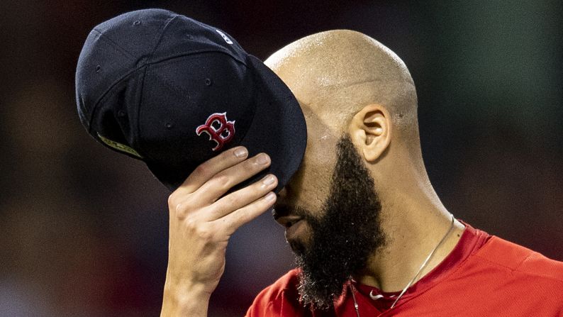 David Price of the Boston Red Sox covers his face with his cap as he exits the game during the second inning of game two of the American League Division Series against the New York Yankees on October 6, 2018 at Fenway Park in Boston, Massachusetts. Price was credited with the loss as the Yankees went on to win the game and tie the series 1-1.