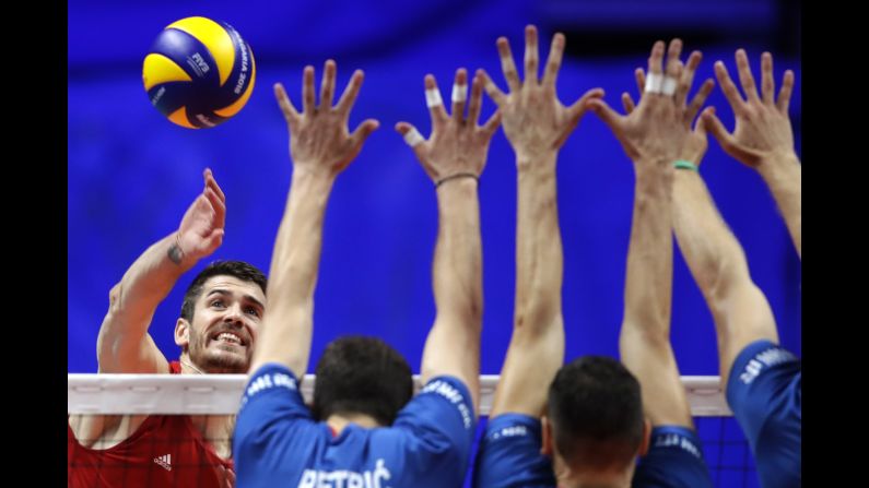 United States' Matthew Anderson, left, spikes as Serbia's Nemanja Petric, Marko Podrascanin, and Drazen Luburic jump to block the ball during the 2018 FIVB Men's World Championship's third place match between USA and Serbia, in Turin, Italy, Sunday, Sept. 30, 2018.