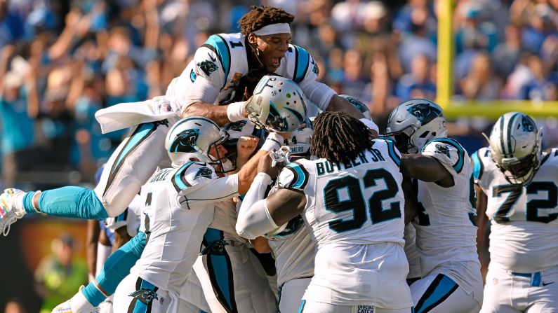 Cam Newton and teammates pile on kicker Graham Gano of the Carolina Panthers after his game-winning 63-yard field goal against the New York Giants during their game at Bank of America Stadium on October 7, 2018 in Charlotte, North Carolina. The Panthers won 33-31.