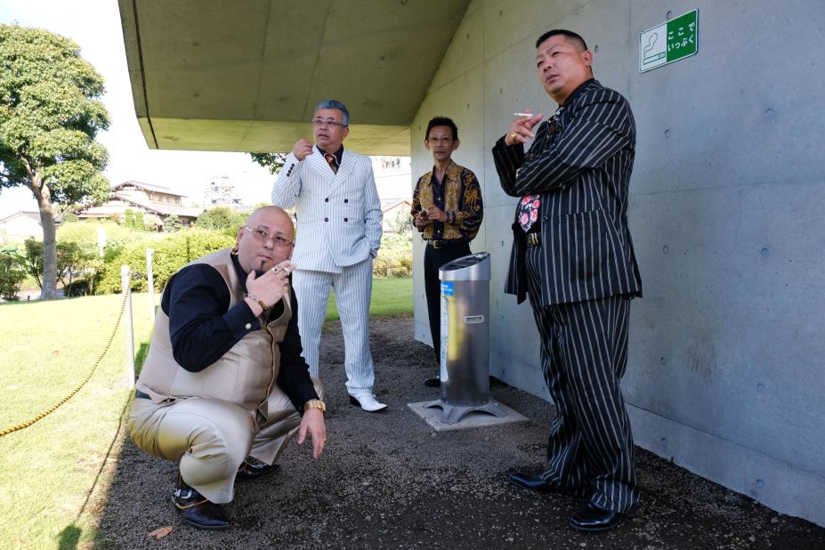 Ryuichi Baba (far left), who goes under the stage name "Arifu Riman," takes a cigarette break with his fellow ex-mobster actors. 