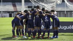 Members of the Thai soccer team "Wild Boars" huddle before a friendly soccer match against River Plate youth team.