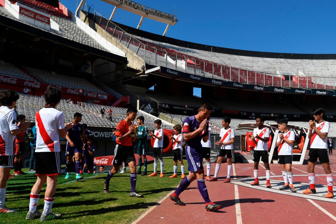 The "Wild Boars" team enter the field for the friendly match against River Plate's youth team.
