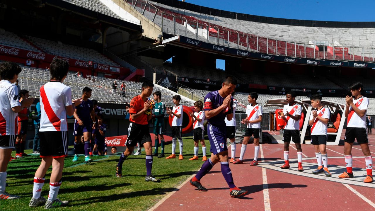 The "Wild Boars" team enter the field for the friendly match against River Plate's youth team.