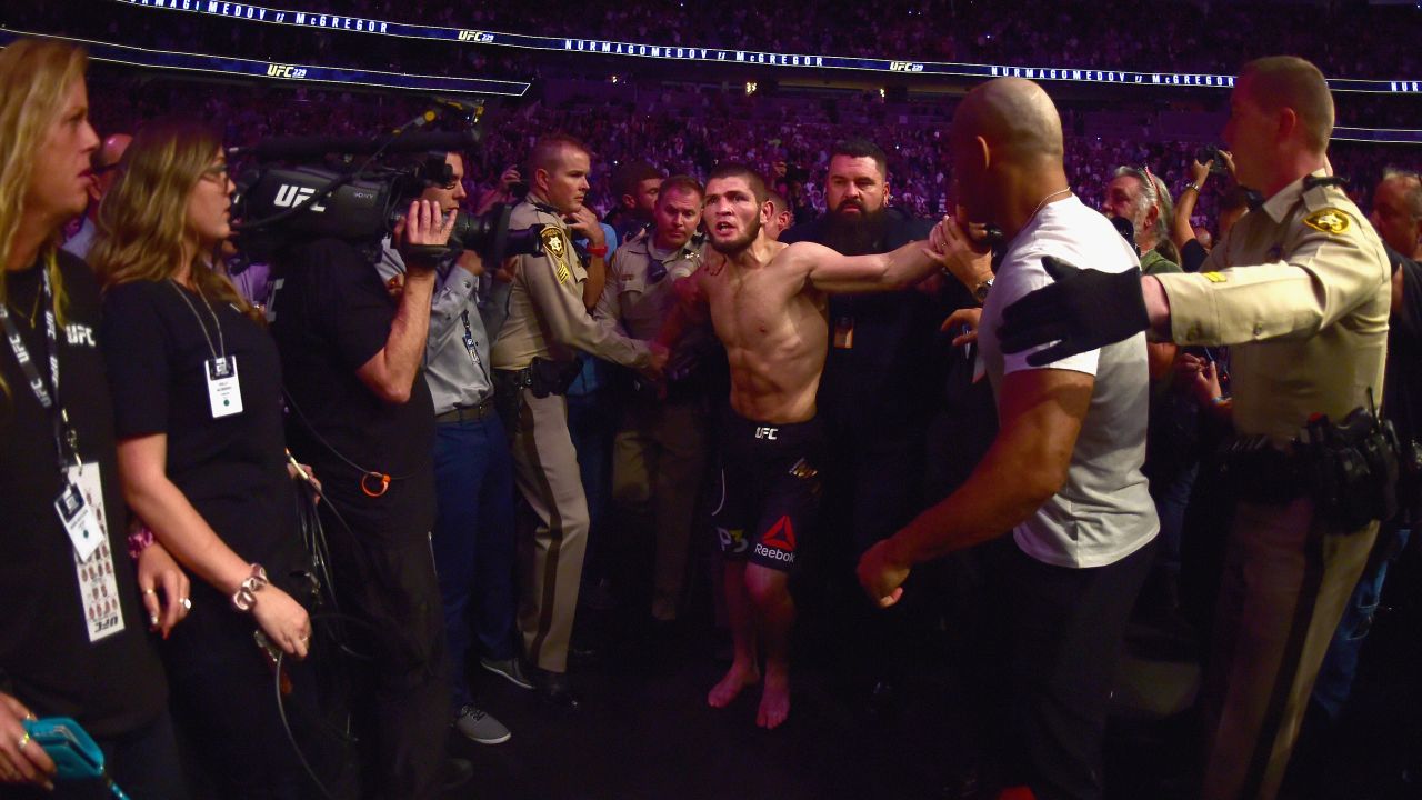 Khabib Nurmagomedov is escorted out of the arena after defeating Conor McGregor in their UFC lightweight championship bout.