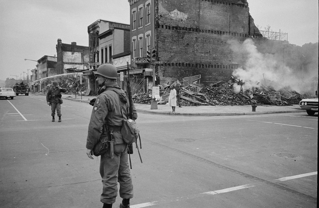 A soldier stands guard in Washington near buildings that were destroyed in the riots that followed the assassination of Martin Luther King, Jr. in April 1968.