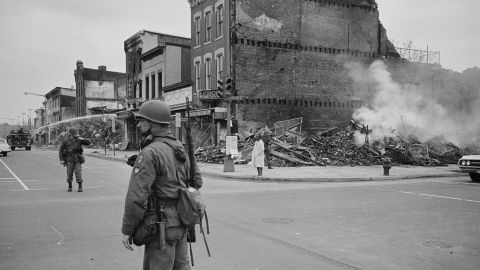 A soldier stands guard in Washington near buildings that were destroyed in the riots that followed the assassination of Martin Luther King, Jr. in April 1968.
