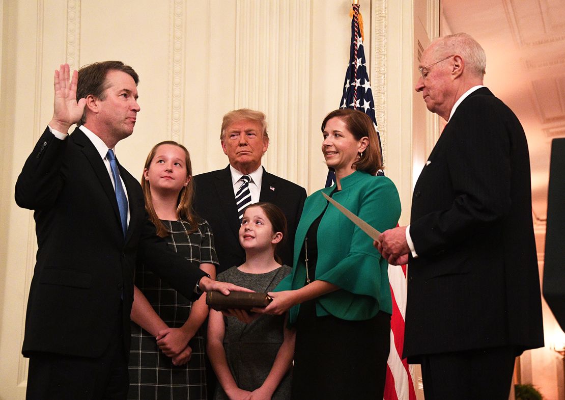 Brett Kavanaugh (L) is sworn-in as Associate Justice of the US Supreme Court by Associate Justice Anthony Kennedy (R) before wife Ashley Estes Kavanaugh (2nd-R), daughters Margaret (2nd-L) and Elizabeth (C), and US President Donald Trump at the White House in Washington, DC.
