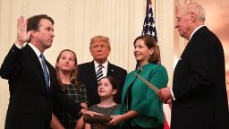 Brett Kavanaugh (L) is sworn-in as Associate Justice of the US Supreme Court by Associate Justice Anthony Kennedy (R) before wife Ashley Estes Kavanaugh (2nd-R), daughters Margaret (2nd-L) and Elizabeth (C), and US President Donald Trump at the White House in Washington, DC. (Photo by Jim WATSON / AFP)        (Photo credit should read JIM WATSON/AFP/Getty Images)